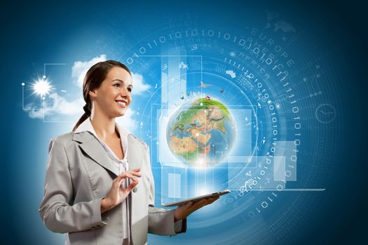 Young businesswoman with tablet pc in hands. Globalization concept. Elements of this image are furnished by NASA