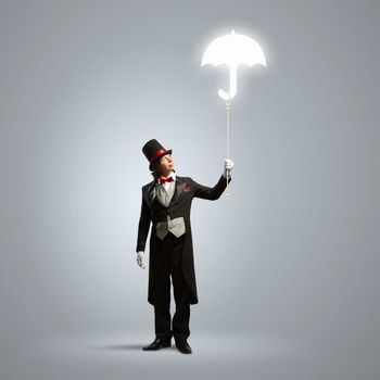 Image of wizard in hat holding umbrella