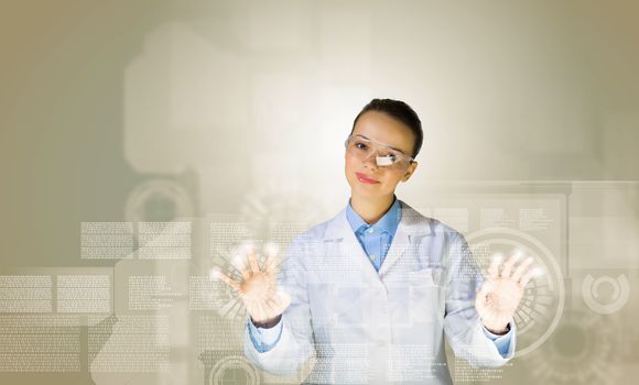 Image of young woman scientist touching icon of media screen