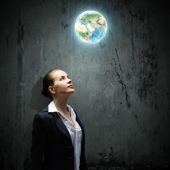 Image of thoughtful businesswoman looking at planet earth