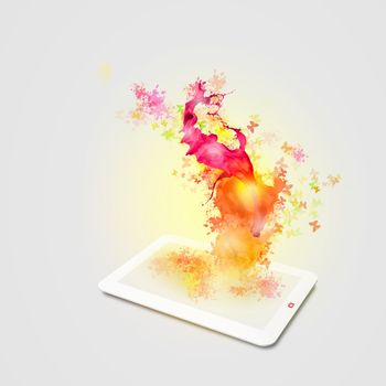 Image of tablet pc with color lights and splashes