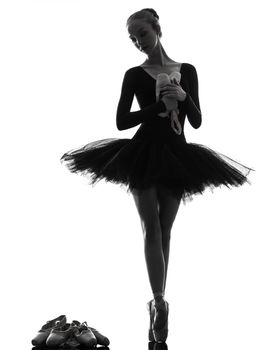 one caucasian young woman ballerina ballet dancer dancing with tutu in silhouette studio on white background