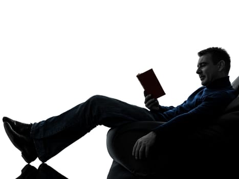 one caucasian man reading book full length in silhouette studio isolated on white background