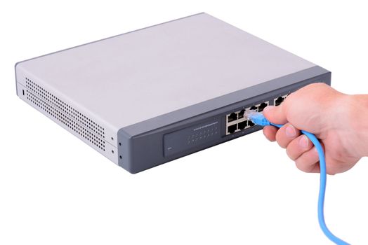 hand pluging an rj45 connector in to a network hub