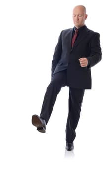 Man in suit stepping on something isolated on white