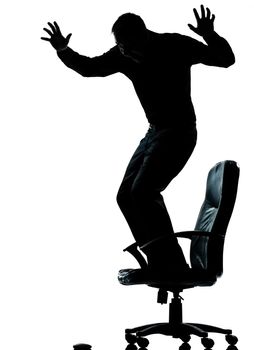 one caucasian business man afraid of computer mouse silhouette Full length in studio isolated on white background