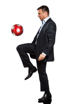 one caucasian business man playing juggling soccer ball in studio isolated on white background