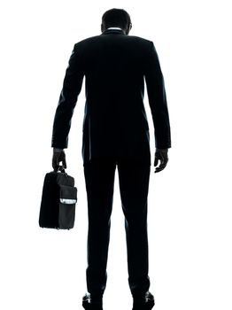 one caucasian business man sad standing rear view  in silhouette studio isolated on white background