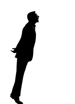 one caucasian business man silhouette standing tiptoe looking up Full length in studio isolated on white background