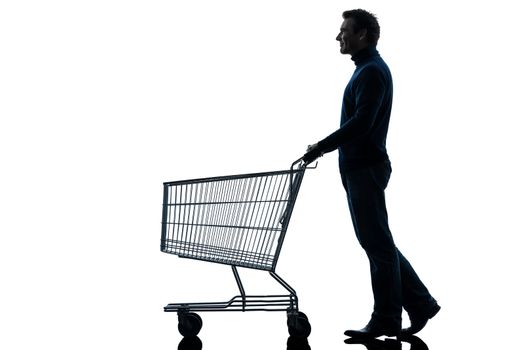 one caucasian man with empty shopping cart in silhouette studio isolated on white background