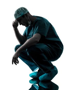 one caucasian man doctor surgeon medical worker despair fatigue tired  silhouette isolated on white background