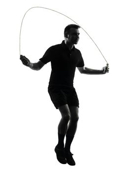 one man exercising jumping rope  in studio silhouette isolated on white background
