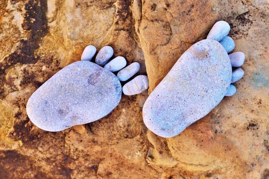 Footsteps of pebbles on the rocky coast