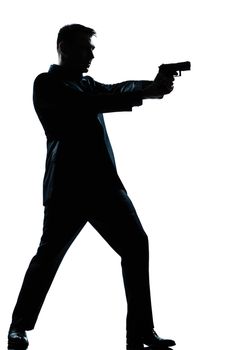 one caucasian  spy criminal policeman detective man aiming shooting gun  full length silhouette in studio isolated white background