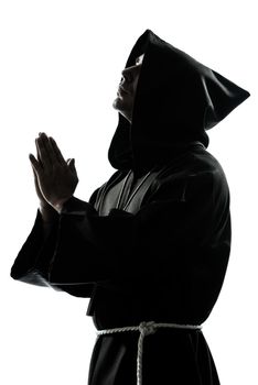 one caucasian man priest praying silhouette in studio isolated on white background