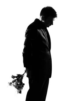 silhouette caucasian business man offering flowers expressing behavior full length on studio isolated white background