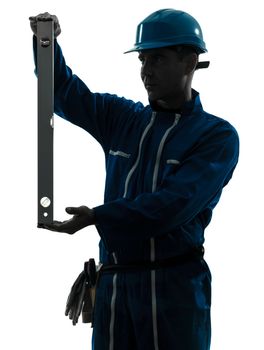 one caucasian man construction worker holding level silhouette in studio on white background