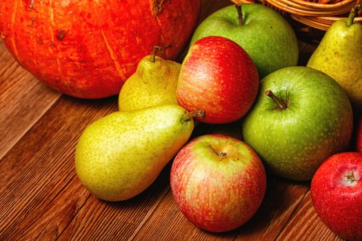 Harvest of ripe fruits and vegetables: apples, pears and pumpkin