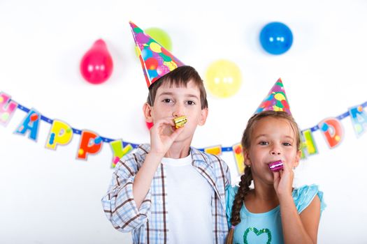 Cute girl and boy having fun at birthday party