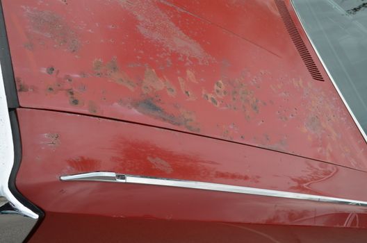 Rust showing on a cars bonnet showing the need for a re spray.