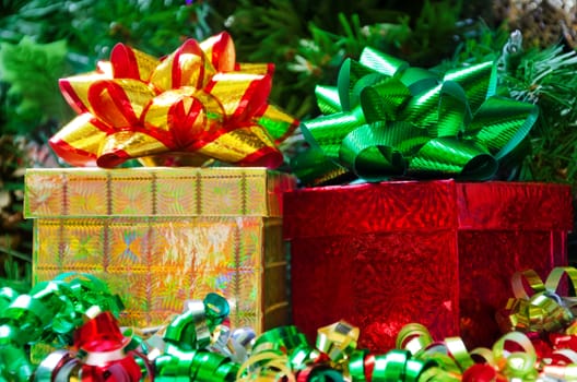 Two gift boxes with bows on the Christmas tree background
