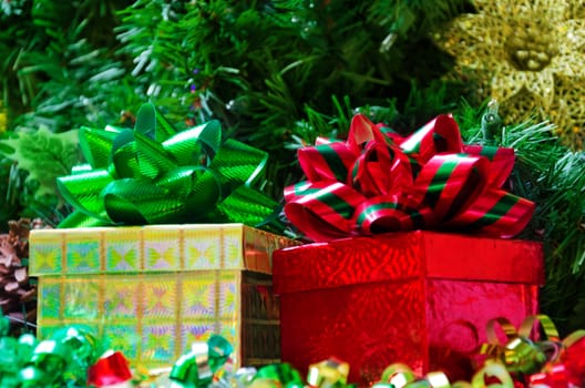 Two gift boxes with bows on the Christmas tree background