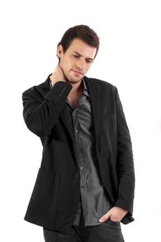 View of a young man standing against a white  background. 