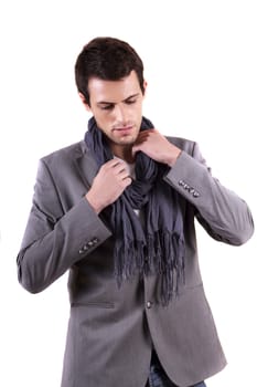 View of a young man standing against a white  background. 