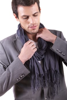 View of a young man standing against a white  background. 