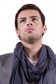 View of a young man standing against a white  background. 