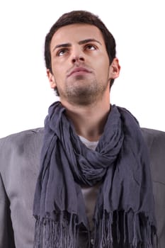 View of a young man standing against a white  background. 