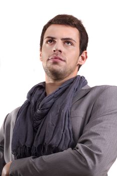 View of a young man standing against a white  background. 