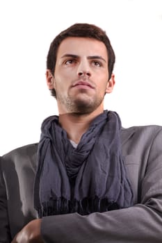 View of a young man standing against a white  background. 