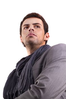 View of a young man standing against a white  background. 