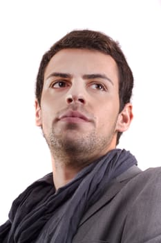 View of a young man standing against a white  background. 