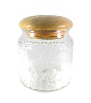 Salt in a glass jar with wood lid isolated