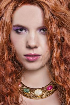 View of a beautiful young natural red hair woman isolated on a white background.