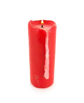 Burning red wax candle on white background