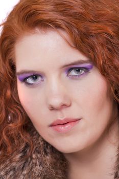 View of a beautiful young natural red hair woman isolated on a white background.