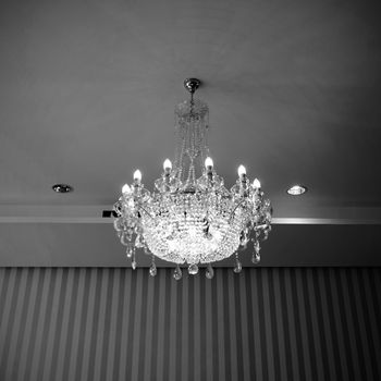 beautiful crystal chandelier in a vintage room, in black and white