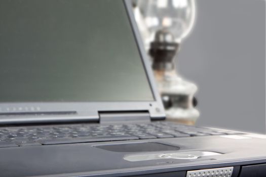 laptop and paraffin lamp in gray ambiance