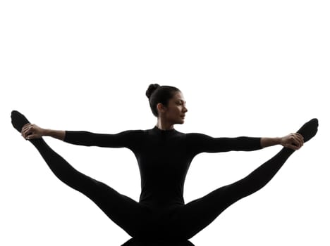 one caucasian woman practicing gymnastic yoga stretching split  in silhouette   on white background