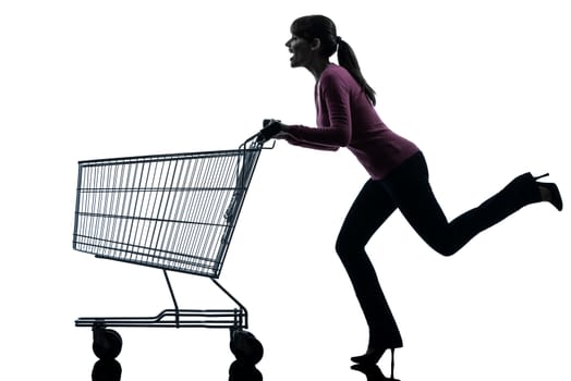 one caucasian woman with empty shopping cart in silhouette studio isolated on white background