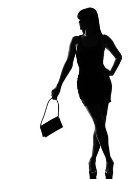 one stylish silhouette caucasian beautiful woman waiting holding purse full length on studio isolated white background