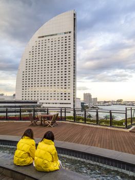 YOKOHAMA, JAPAN - DEC 12: Unidentified women look at the InterContinental Yokohama Grand Hotel on December 12, 2010 in Yokohama, Japan. This hotel is shaped like a yacht under sail evoke to the ocean.