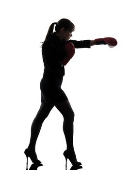 one business woman punching with boxing gloves  silhouette studio isolated on white background