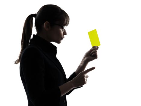 one business woman showing yellow card  silhouette studio isolated on white background