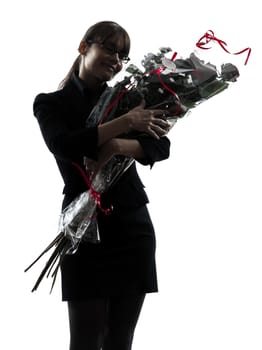 one business woman hugging flowers bouquet  silhouette studio isolated on white background