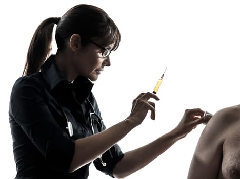 one woman doctor holding surgical needle vaccination silhouette studio isolated on white background