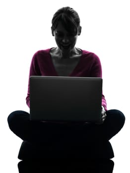 one caucasian woman happy smiling computing laptop computer  in silhouette studio isolated on white background